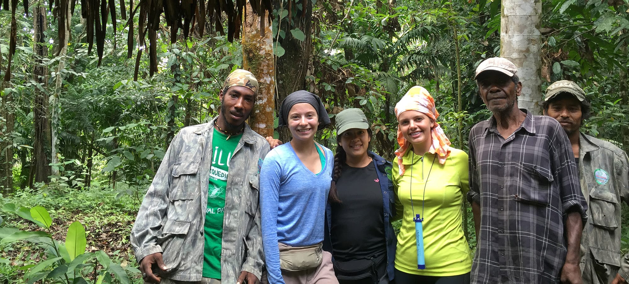 Redding and Kelsey Johnson with their guides at a jungle campsite